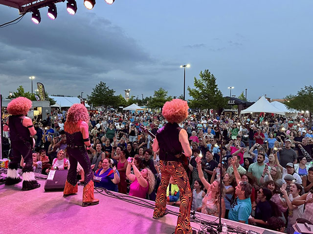 [Band on Stage in Front of Crowd]